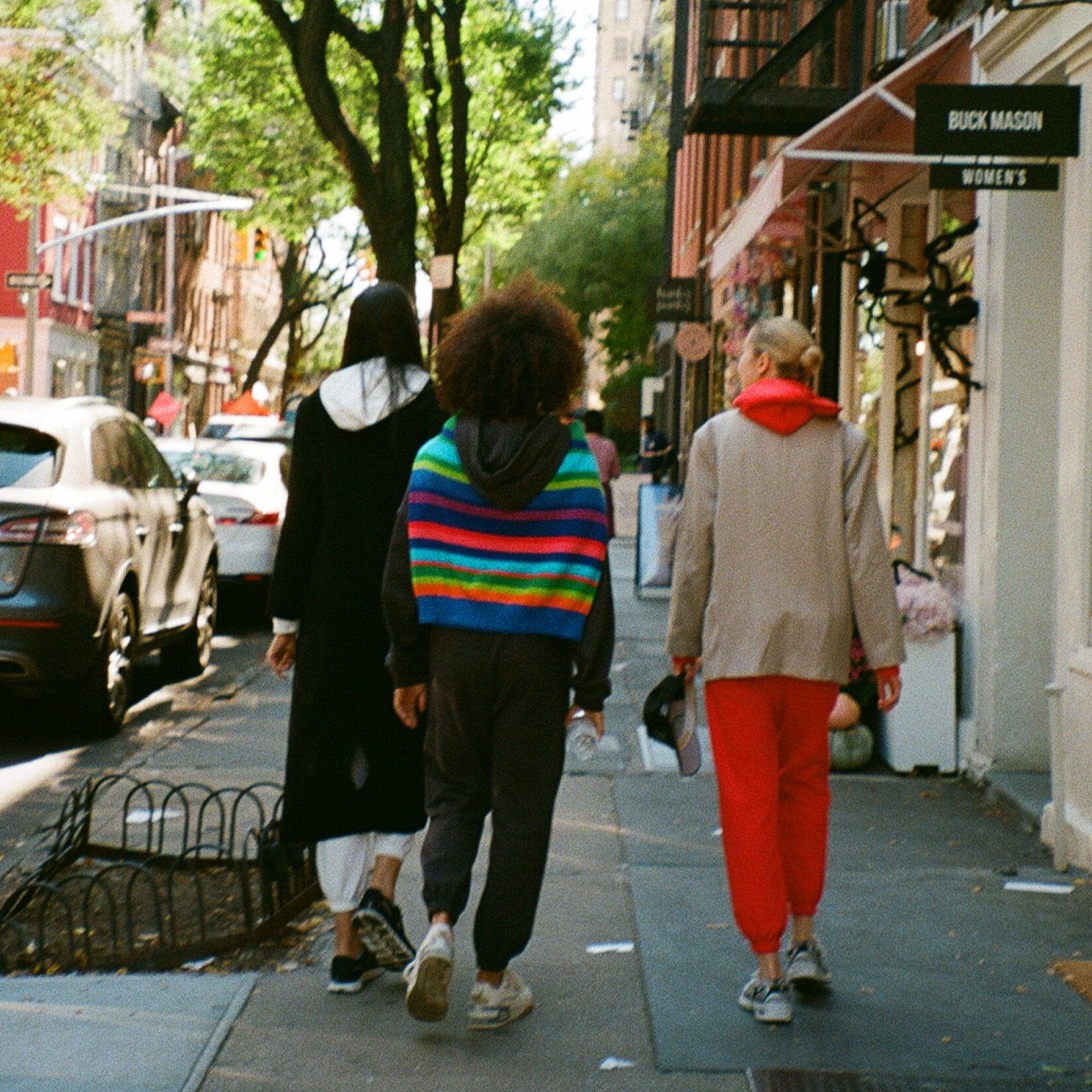 Models in white, gray and red sweatsuits with accent pieces.